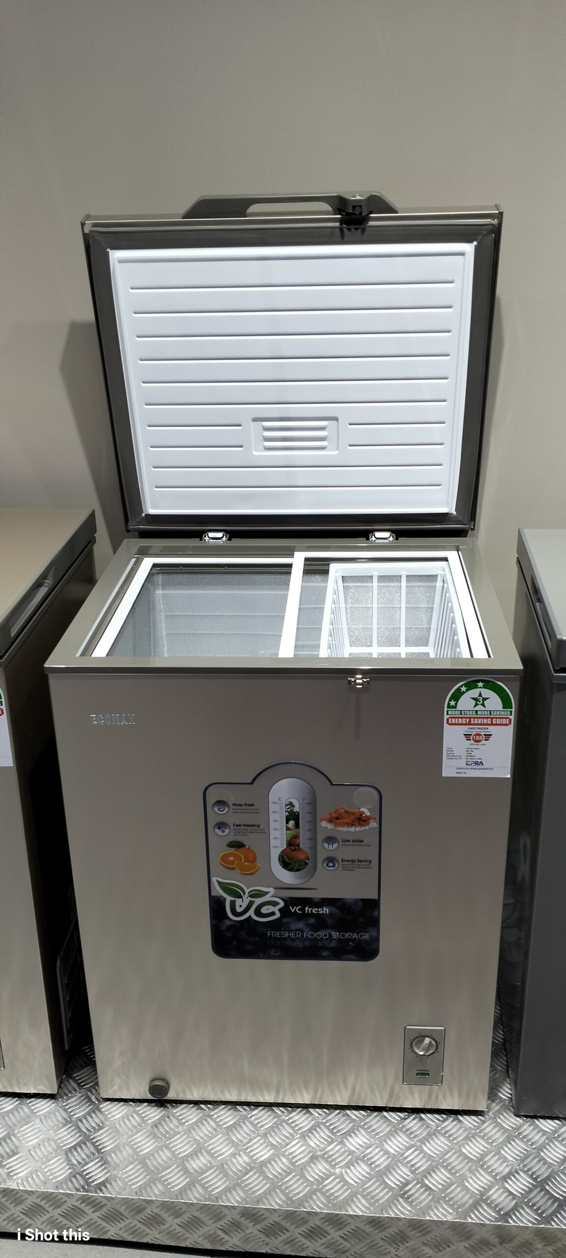 Interior of Ecomax 169L freezer showing sliding glass lid and plastic basket