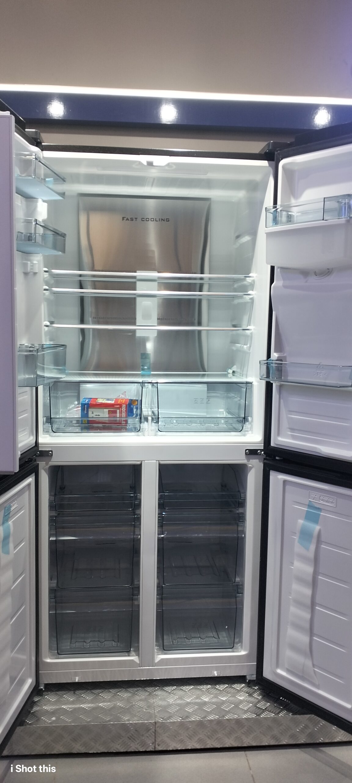 Open view of Ecomax 506L fridge showing internal glass shelves, LED lighting, dual vegetable baskets, and freezer drawers
