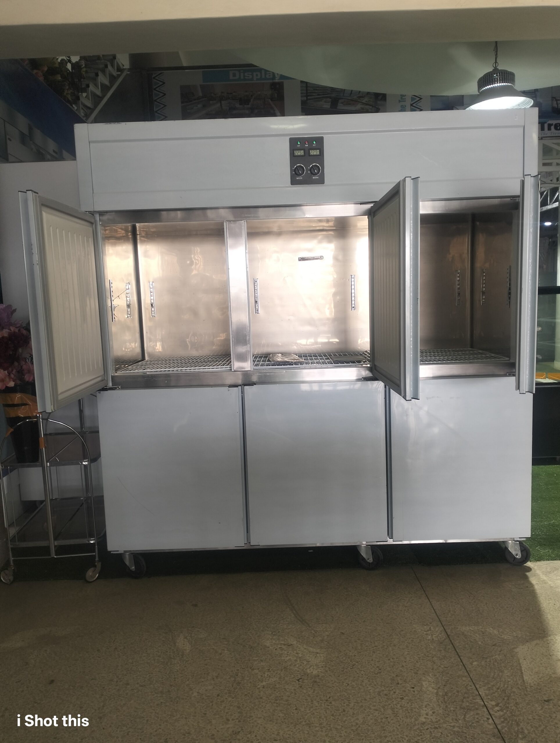 Kitchen freezer with doors open showing interior shelving